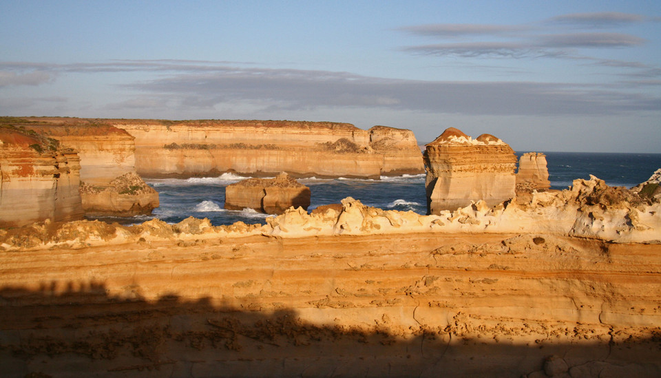 Sunlit coastal fortifications beside blue water