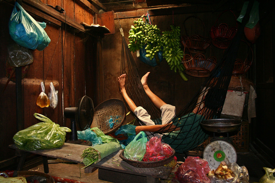 A vendor preparing vegetables at a market